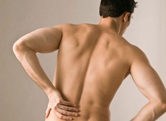 man with shirt off in lower back pain