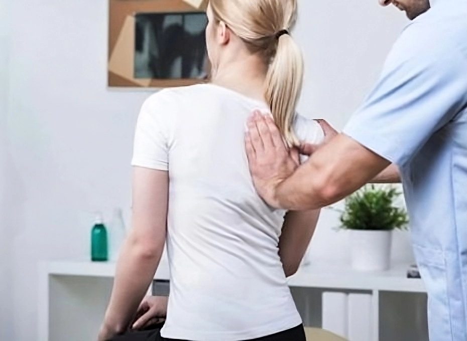 chiropractic adjustment on womans back with doctors hand